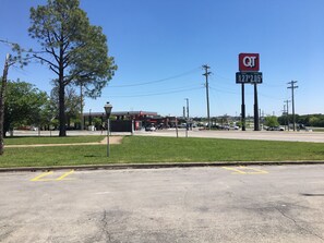 A parking lot with a gas station in the background.