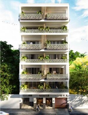A multi-story building with balconies, windows, and a ground-level entrance. - Casa Iguana at Carranza (Puerto Vallarta)