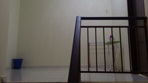 A staircase with a metal railing leading to a landing. - NEWLINA HOMESTAY, Nibong Tebal, Seberang Perai Selatan, Penang, Malaysia. (Nibong Tebal)