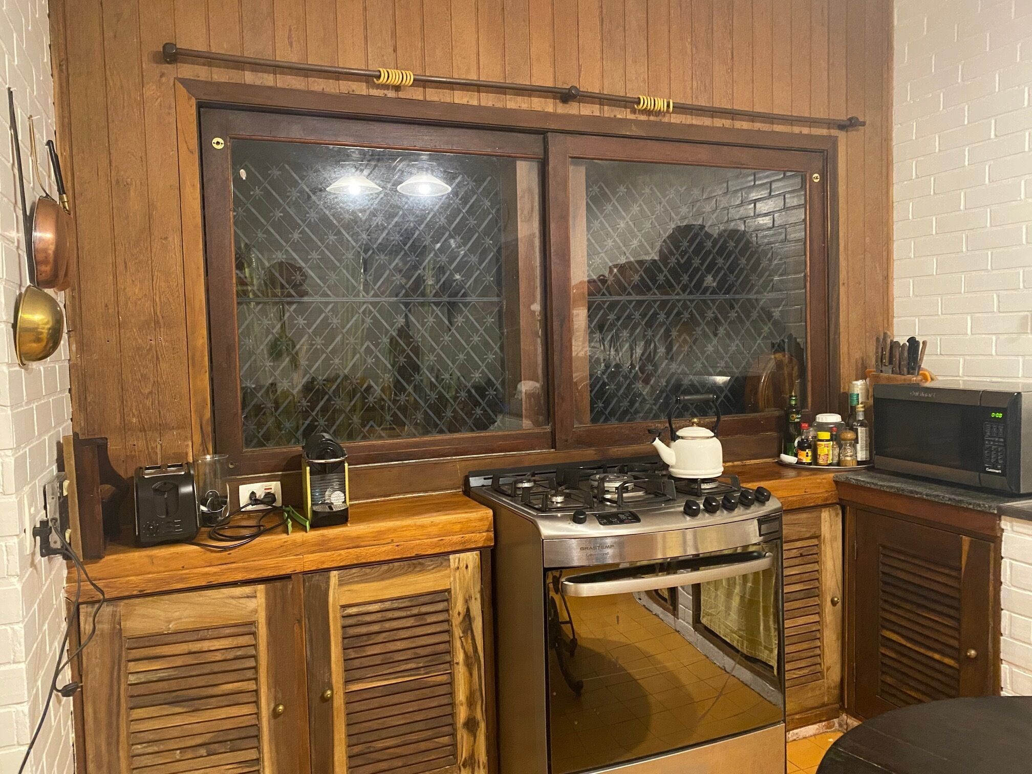 Colonial house with a smaller house on the edge of a river and along the forest.