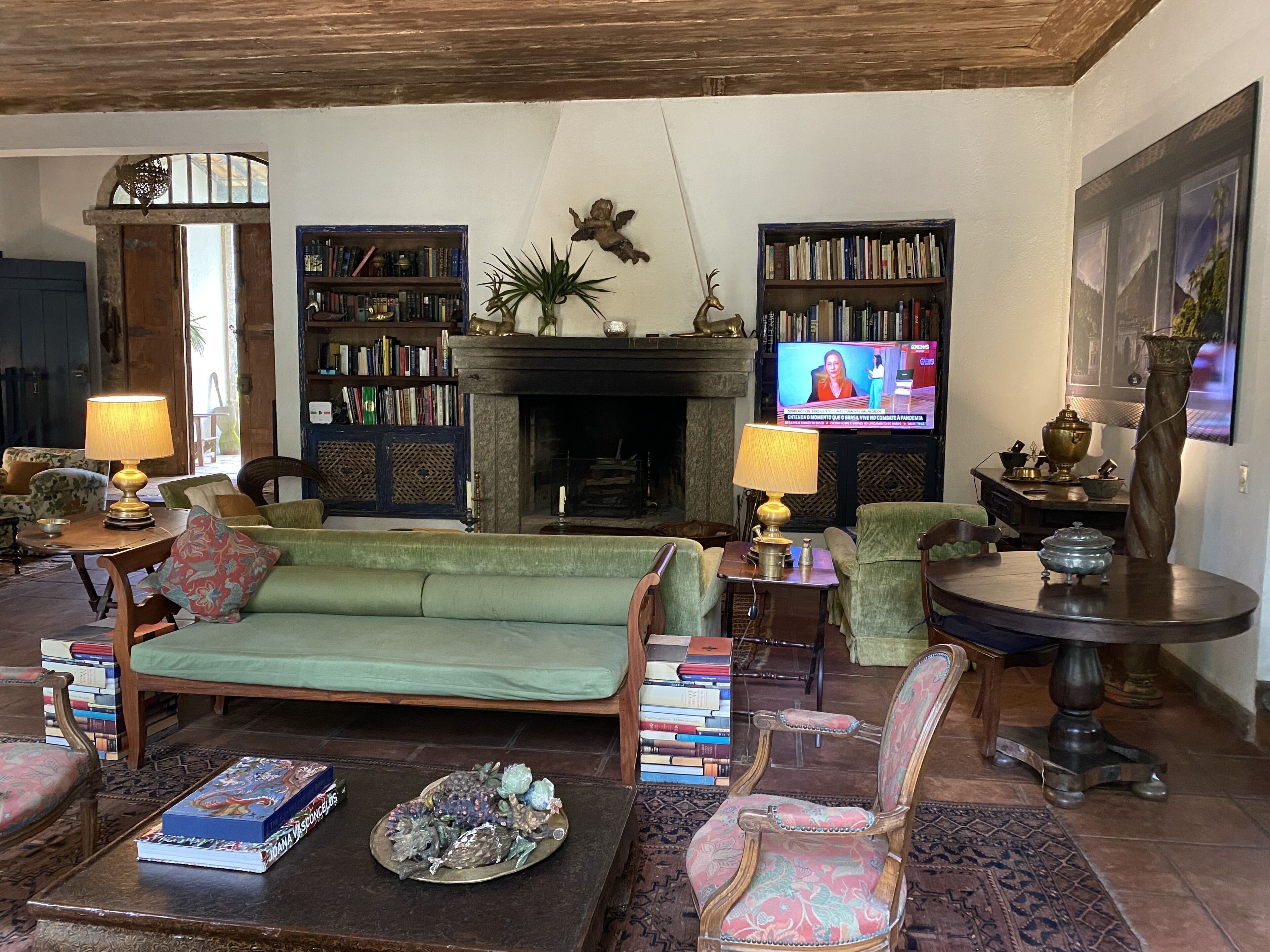 Colonial house with a smaller house on the edge of a river and along the forest.