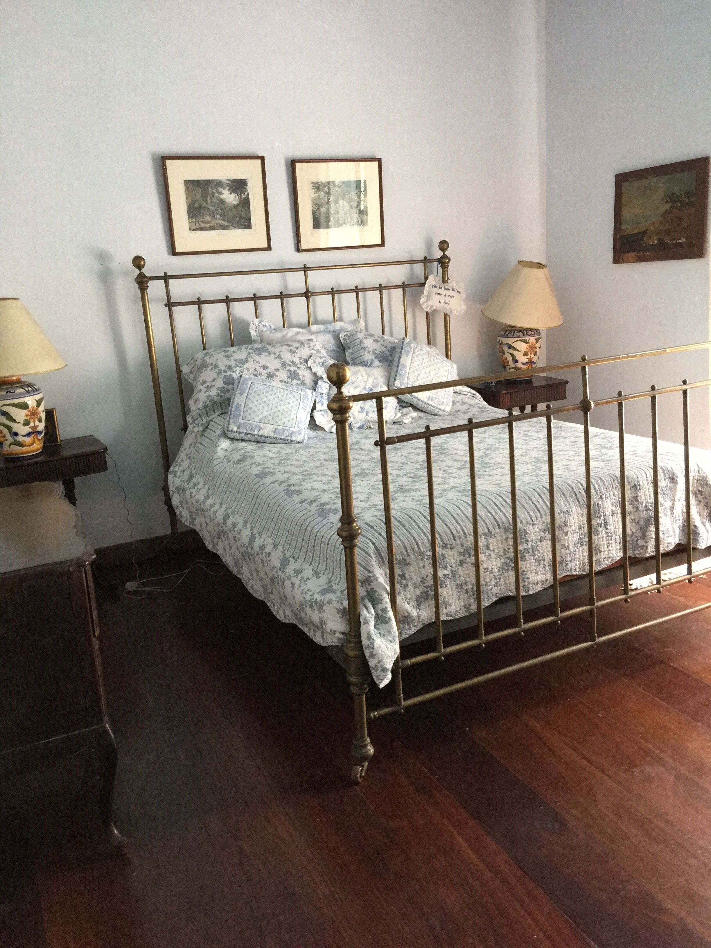 Colonial house with a smaller house on the edge of a river and along the forest.