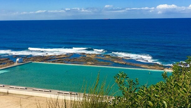 A pool with a view of the ocean and rocky shoreline. - Walk to the Beach | Live Like A Local | All The Comforts Of Home (Newcastle)