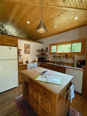 Enjoy cooking in this well-equipped kitchen with a central island and ample counter space.
