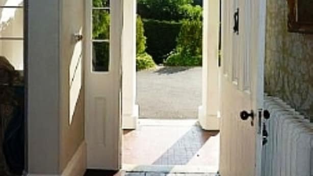 A hallway with a white door leading to a garden. - Georgian Manor With Panaromic Sea Views (Torquay, Devon)