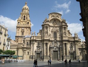 Explore the grand architecture and cultural significance of this historic landmark, featuring intricate carvings and a prominent bell tower.