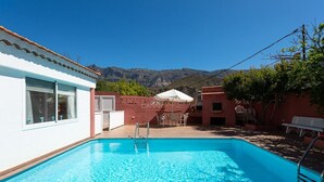 A swimming pool with a clear view of mountains in the background.