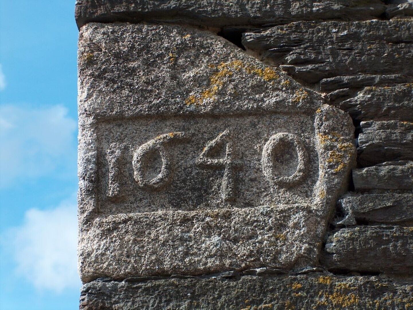A stone wall with the number 1040 carved into it.