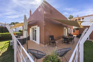 A patio with outdoor furniture, a table, and a chair. - CoolHouses Algarve Luz|Casa das Amendoeiras (Luz)