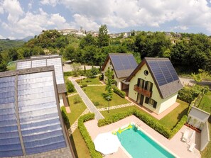 A residential area with houses featuring solar panels, a swimming pool, and a well-maintained garden. - The 5 Sisters Residence (coreglia antelminelli)