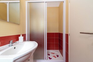 Shower, hair dryer, towels, toilet paper