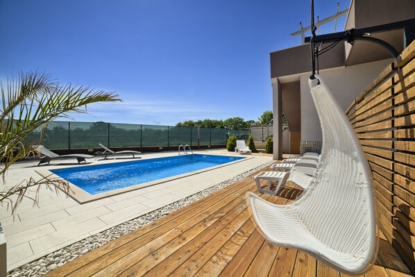 Outdoor pool, a heated pool, pool loungers