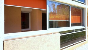 A building with large windows and a beige exterior.