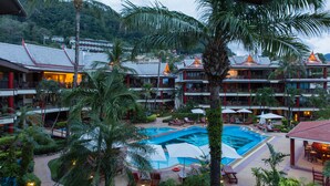 A resort with a large pool, multiple levels of buildings, and lush greenery. - ROMANTIC AND DESIGN APARTMENT, PATONG BEACH (PATONG)