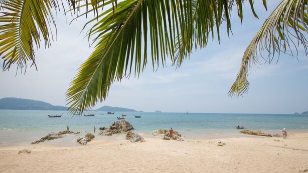 A beach with clear skies, calm water, and boats in the distance. - ROMANTIC AND DESIGN APARTMENT, PATONG BEACH (PATONG)