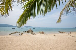 A beach with clear skies, calm water, and boats in the distance. - ROMANTIC AND DESIGN APARTMENT, PATONG BEACH (PATONG)