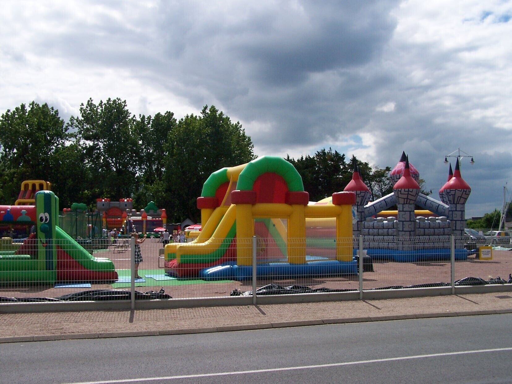 An inflatable play area with slides and castle-like structures.