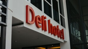 A hotel sign with the name "Deli Hotel" in large red letters. - Deli Hotel (Medan)