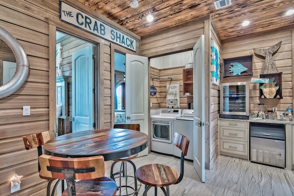 Cozy kitchen with dining area, washer, dryer, and refrigerator, perfect for a home away from home.