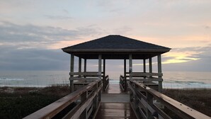 A wooden pier leading to a gazebo by the ocean. - BEACH TIME!  Ocean side! Private area, no crowds - Steps from sand.  Downstairs. (Atlantic Beach)