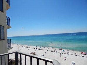 A beach view from a balcony with a clear sky, sandy beach, and ocean. - Renovated 8th-Floor Beachfront Condo with Stunning Sunset Views (Panama City Beach)