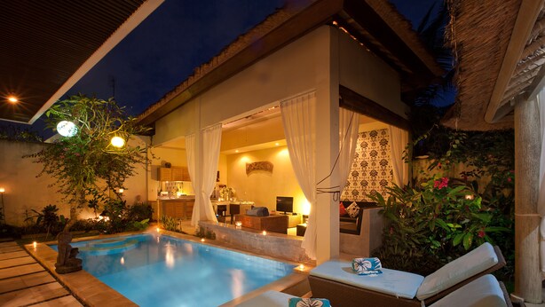 A poolside area with lounge chairs, a small pool, and a well-lit interior space. - Peaceful, Cozy Villa with Private Pool and Good Internet (Mia) (Pererenan)