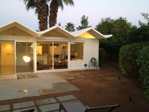 A modern house with a patio, large windows, and a well-maintained garden. - Palm Springs Mid - Century Modern (Palm Springs)