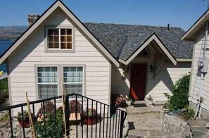 Welcome to a charming single-story home with a gabled roof and inviting front entrance.