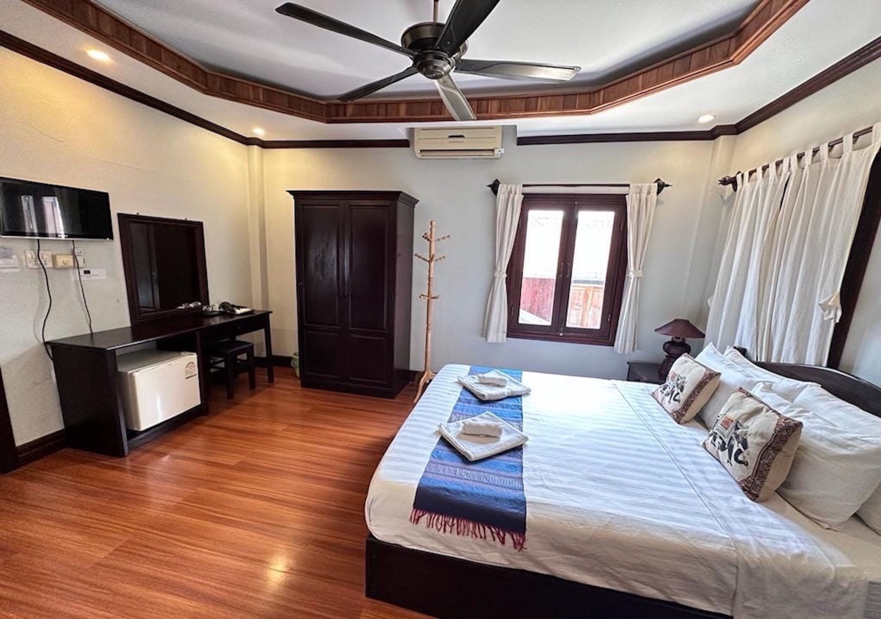 Une chambre à coucher avec un lit, un bureau et une armoire.