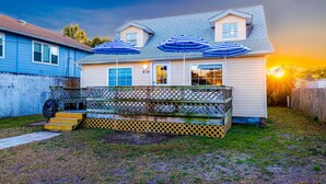 A two-story house with a porch, number 215, and blue umbrellas. - Beach Cottage Heart of Ocean Drive Sleeps 14 (North Myrtle Beach)
