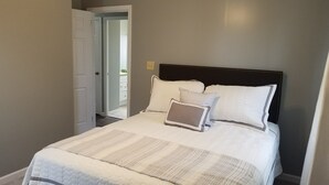 A neatly made bed with a quilted bedspread, two pillows, and a laptop on the bed. - Cozy 3 Bedroom Ranch No steps (Tiffin)