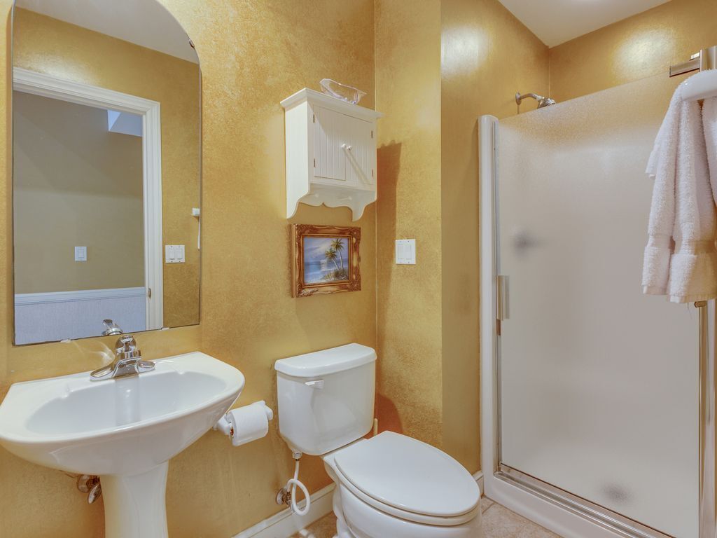 A bathroom with a sink, toilet, and shower.