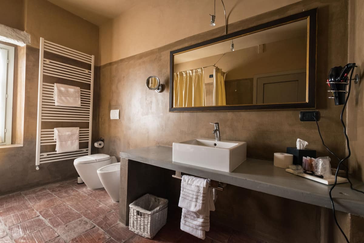 superior suite | bathroom | deep-soaking bathtub, rainfall showerhead, free toiletries, hair dryer
