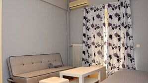 A modern room with a sofa, a small table, and a bed. - Smart Location (Athens)