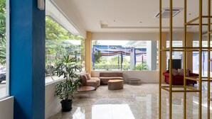A spacious lobby with a marble floor, seating area, and large windows offering a view of the outdoors. - Townhouse Oak Medan near Universitas Sumatera Utara formerly Raz Residence (Medan)