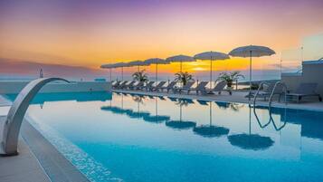 Indoor pool, seasonal outdoor pool, pool umbrellas, pool loungers