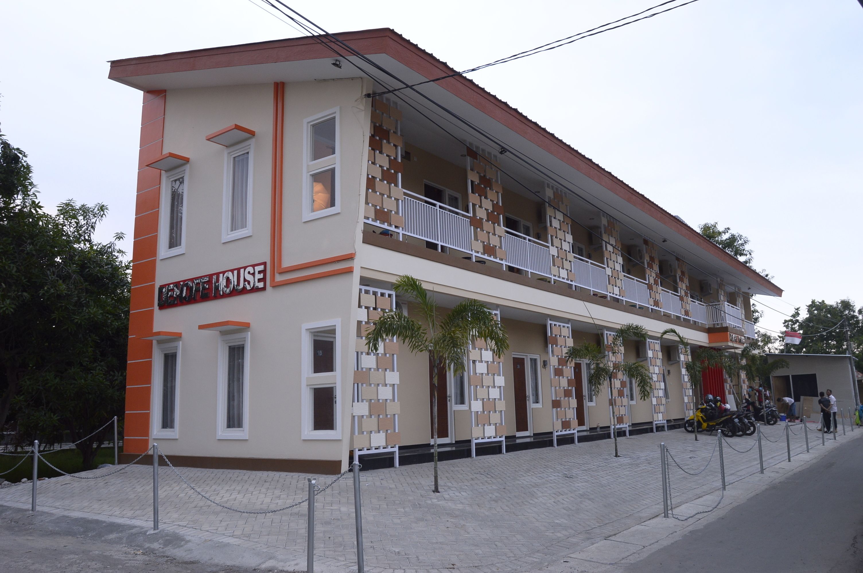 A two-story building with a sign reading "HOTEL HOUSE".