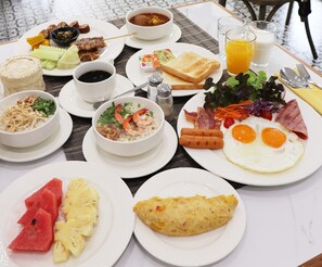A breakfast buffet with various dishes including eggs, toast, and fruit. - Lanna Oriental Hotel (Chiang Mai)