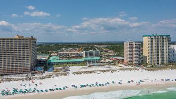 A coastal resort with beachfront hotels, a sandy beach, and ocean views.
