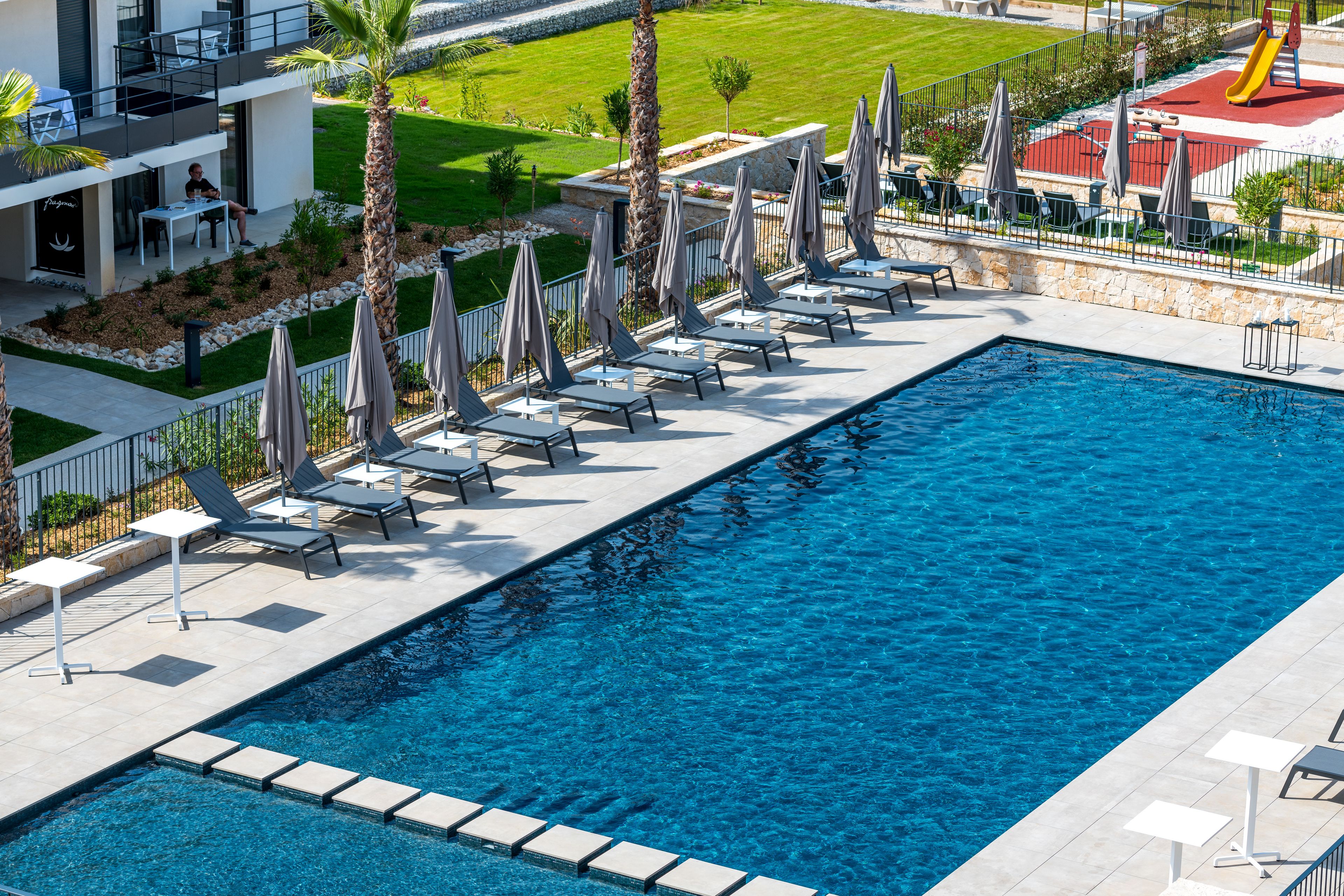 Seasonal outdoor pool, pool loungers