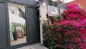 A boutique b&b with a modern entrance, a visible number '6', and a vibrant bougainvillea plant. - La Foresteria Garden Boutique B&B (Catania)