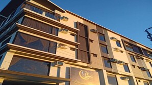 A multi-story hotel with a modern design, featuring large windows and balconies. - Treasure Island Hotel (Masbate City)