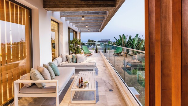A modern balcony with a sofa, chairs, and a coffee table. - Sofia Luxury Residence (Paphos)