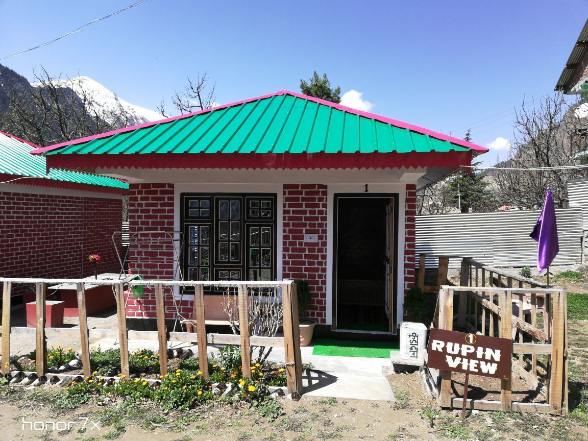 A brick building with a green roof and a sign reading "RUPIN VIEW".