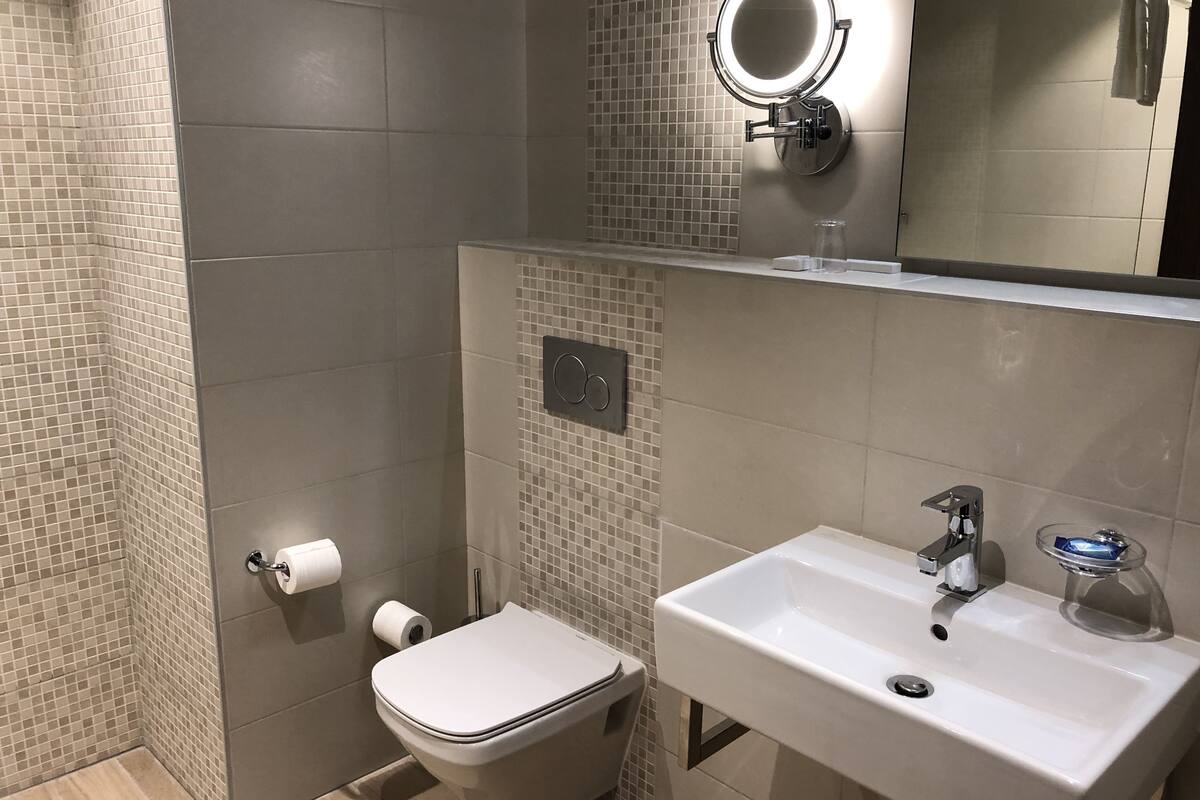 comfort single room, city view | bathroom | free toiletries, hair dryer, bathrobes, slippers