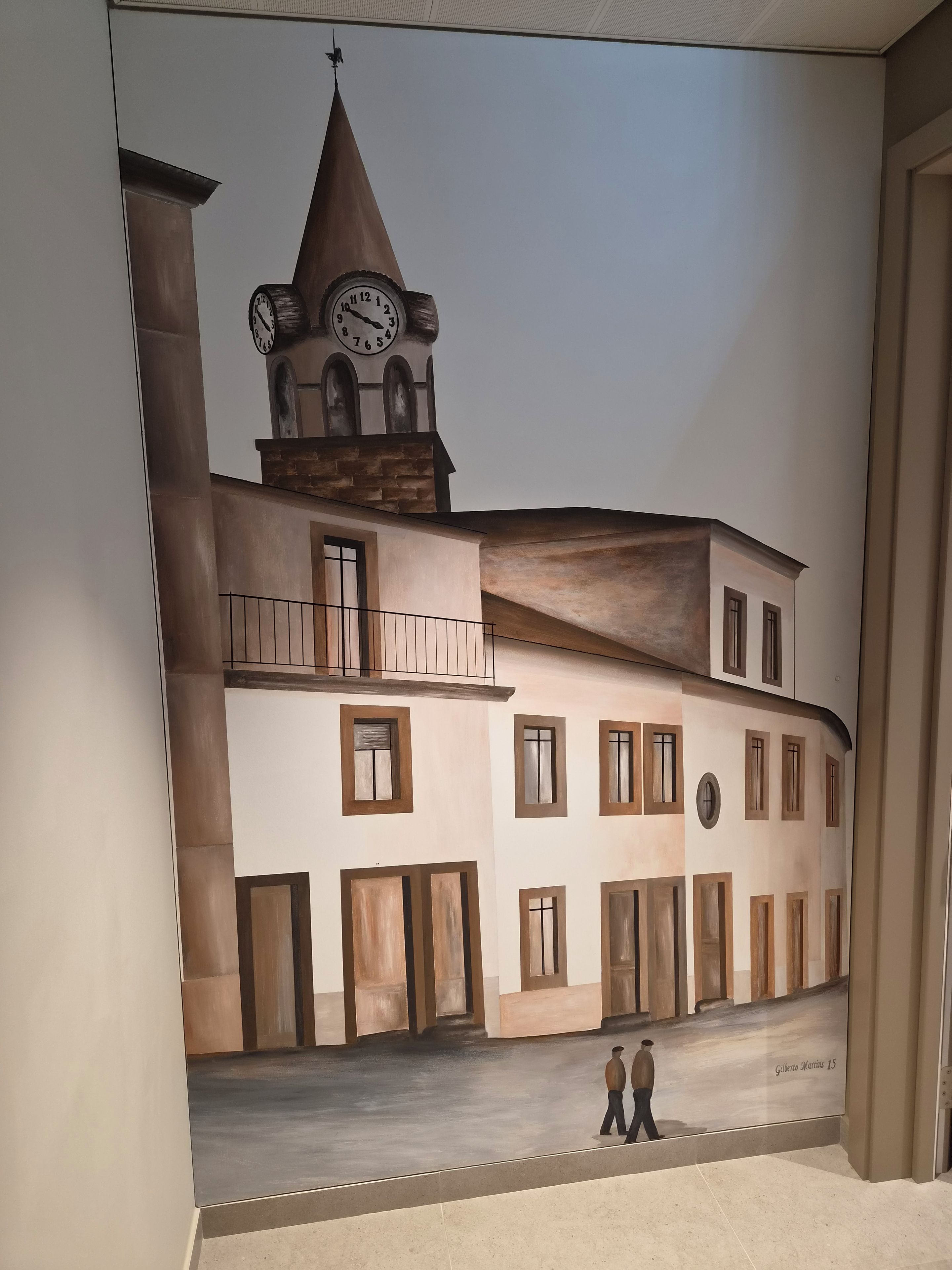 A building facade with a clock tower, multiple windows, and a mural of two figures.