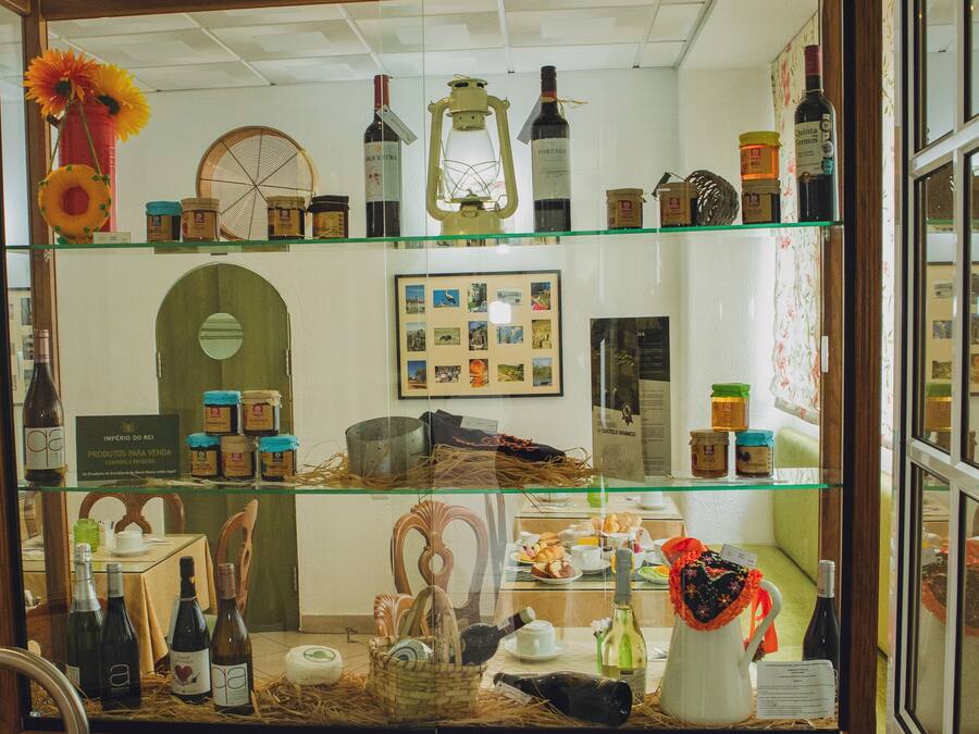 A display case with various bottles and jars, a framed collage, and some decorative items.