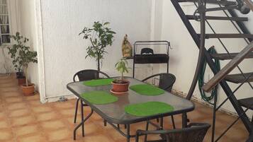 Enjoy al fresco dining in this charming outdoor space with a table and four comfortable chairs.