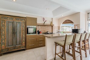 Fridge, stovetop, electric kettle, cookware/dishes/utensils