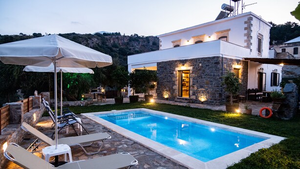 A modern villa with a swimming pool, stone walls, and outdoor furniture. - Traditional Villa in Fres (Apokoronas)